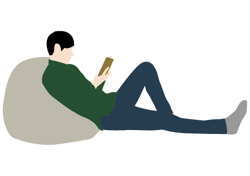 くつろぎながら読書する男性